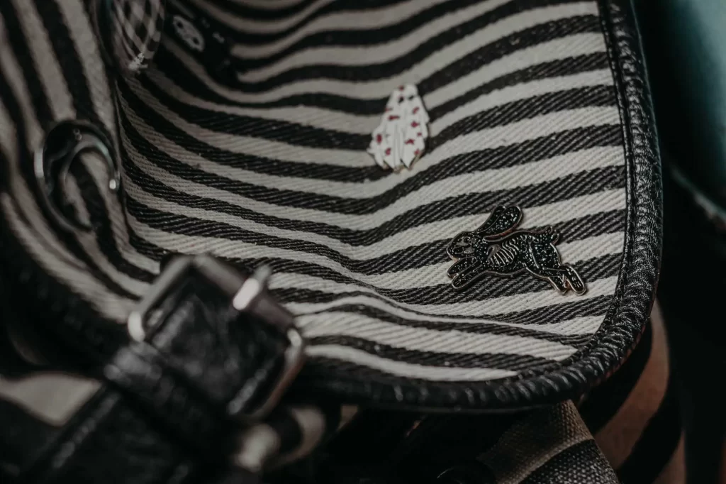 grunge striped backpack with pins macro