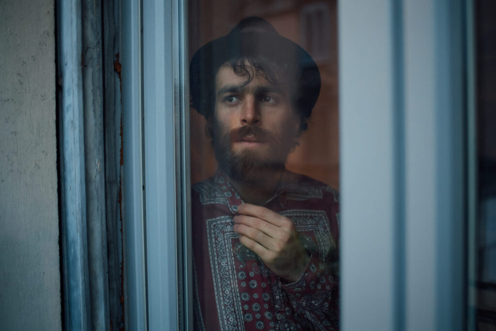 Bearded,Young,Man,In,Deep,Thought,By,Window